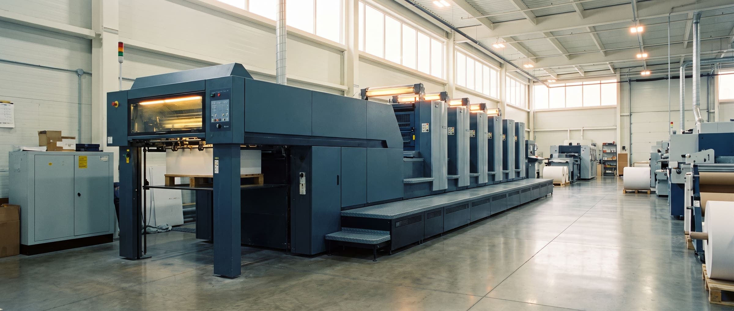 Wide interior view of the Blackwood, NJ press hall with offset presses receding down the production floor