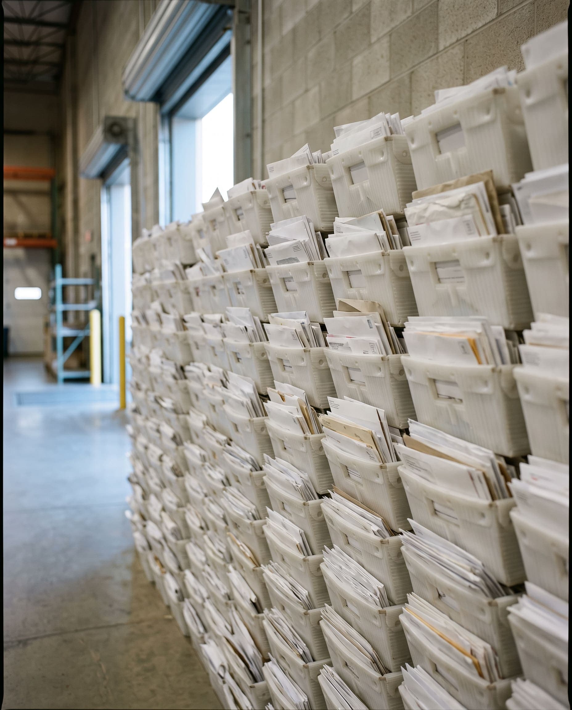 USPS mail trays stacked and staged for pickup
